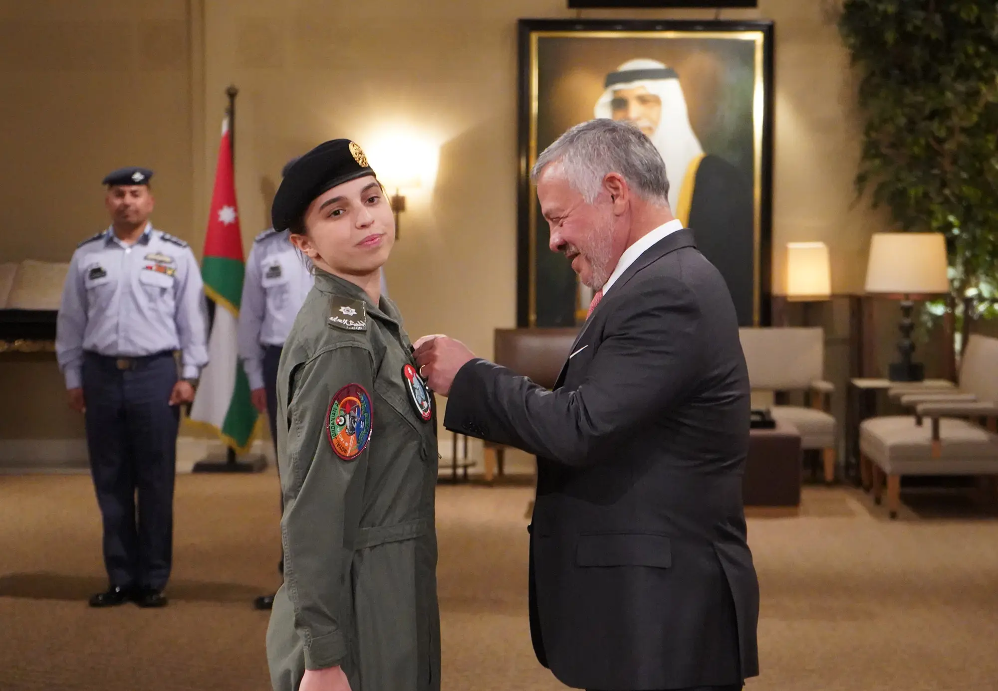 King presents Princess Salma with wings upon completing pilot training